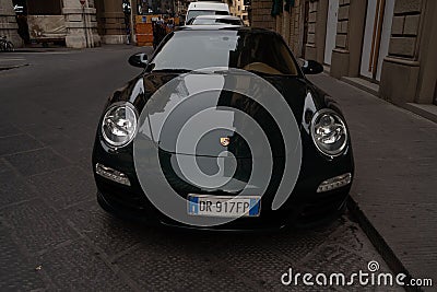 Closeup shot of a black Porsche parked on the side of a quiet street Editorial Stock Photo
