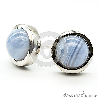 Closeup shot of blue lace agate ear studs behind a white background Stock Photo