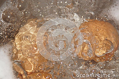 Closeup shot of boiling water with brown eggs on a stainless casserole Stock Photo