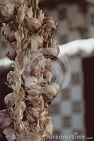 Closeup shot of a braided string of garlic with blurry background Stock Photo