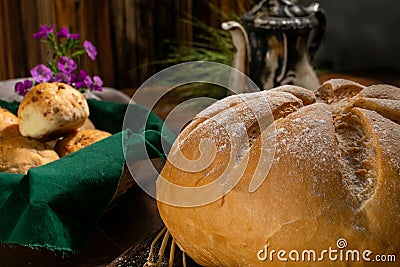 Closeup shot of bread with a flower cut from the top beside a bread bowl Stock Photo