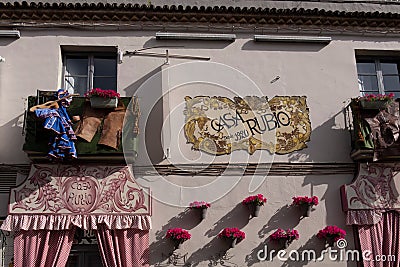 Closeup shot of building wall with balconies, flowers and curtains in street in Cordoba city, Spain Editorial Stock Photo