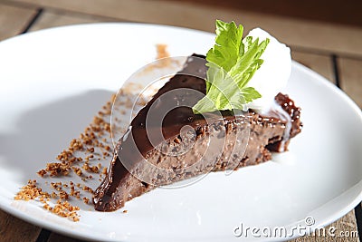 Closeup shot of chocolate dessert with peanut and walnut pieces on a white plate background Stock Photo