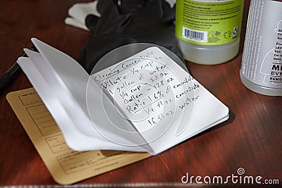 Closeup shot of cleaning concentrate handwritten recipe next to cleaning products and gloves Stock Photo