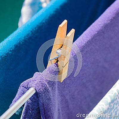 Closeup shot of clothes attached with a wooden pin on a clothesline Stock Photo