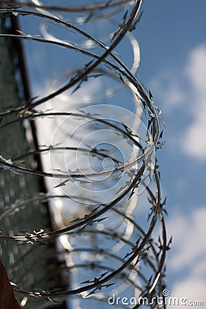 Closeup shot of concertina wire with a blurry background Stock Photo