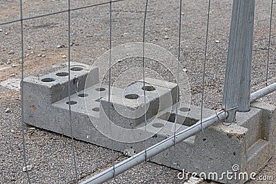 Closeup shot of a concrete stand and a wire fence attached to it Stock Photo