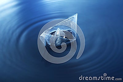 Closeup shot of a crystal figure on a water surface making circle waves Stock Photo