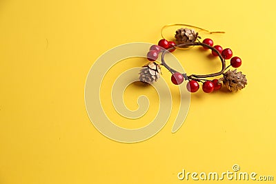 Closeup shot of a decorative wooden trinket isolated on a yellow background Stock Photo