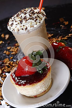 Closeup shot of the delicious creamy pastry with a cup of frappuccino with whipped cream Stock Photo