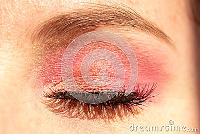 Closeup shot of eye makeup with pink shadow and heavy mascara Stock Photo