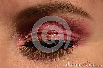 Closeup shot of eye makeup with pink shadow and heavy mascara Stock Photo