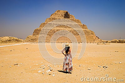 Closeup shot of a female standing in front of a Pyramid in Egypt Stock Photo