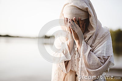 Closeup shot of a female wearing a biblical robe crying - concept confessing sins Stock Photo