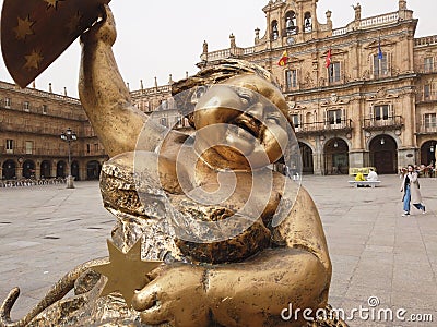 Closeup shot of a golden statue of a happy woman in the big square in the center of Salamanca, Spain Editorial Stock Photo