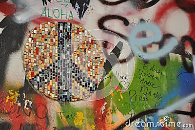 Closeup shot of a graffiti and peace sign mosaic at the John Lennon Wall in Prague, Czech Republic Editorial Stock Photo
