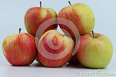 Closeup shot of a group of apples on a blue background. Stock Photo