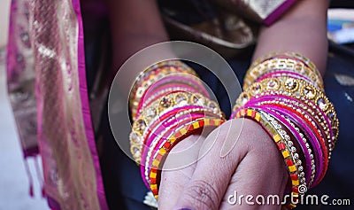 Closeup shot of hands of Indian female wearing colorful bangles Stock Photo