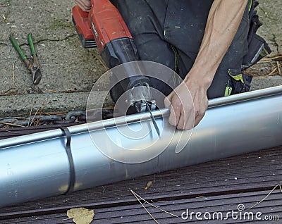 Closeup shot of a handyman slicing metal with an industrial cutter Stock Photo