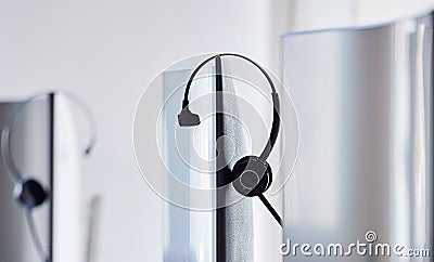 We are unavailable right now, be try again later. Closeup shot of a headset resting on a computer monitor in a call Stock Photo