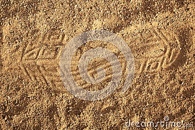 Closeup shot of an imprint of a shoe on a sandy ground Stock Photo