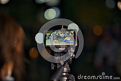Closeup shot of the iPhone live streaming with bokeh background Editorial Stock Photo