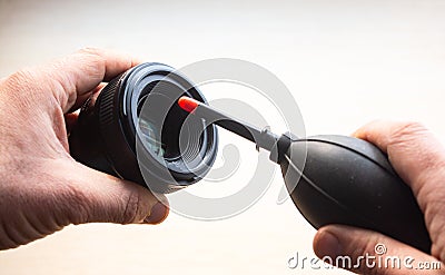 Closeup shot of male hands cleaning a photographic lens Stock Photo