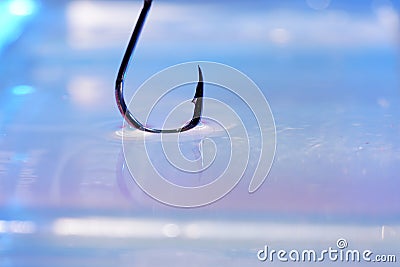 Closeup shot of a metal sharp hook on a water surface Stock Photo