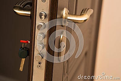 Closeup shot of modern door lock with a key. Empty space Stock Photo