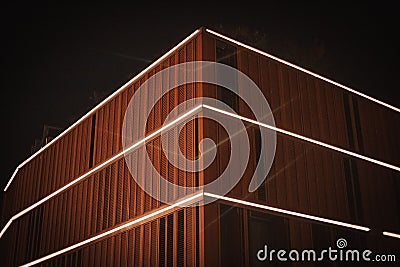 Closeup shot of a modern wooden building with lights on in Poland, Wroclaw Editorial Stock Photo