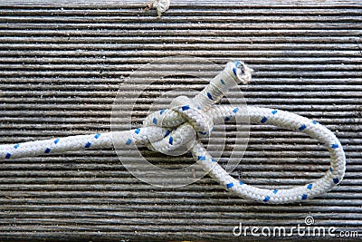 Closeup shot of nautic knot on wooden background Stock Photo