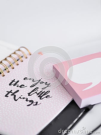 Closeup shot of a notebook with a writing "enjoy the little things" Stock Photo