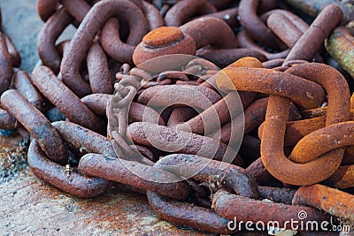 Closeup shot of old rusted chains on the ground Stock Photo