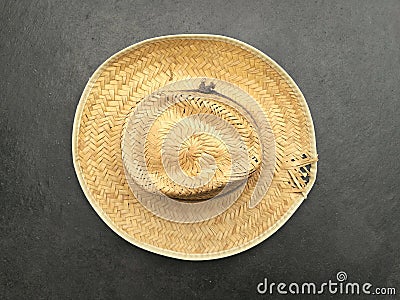 Closeup shot of an old straw hat made of raffia on gray background Stock Photo