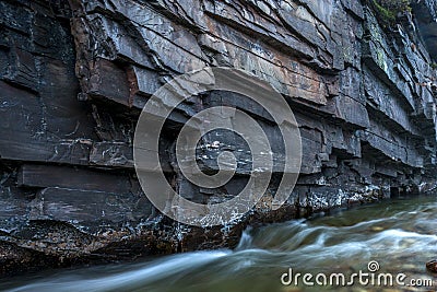 Closeup shot of old textured glacial rocks by the bridal veil waterfalls in rondane national park in norway. Stock Photo