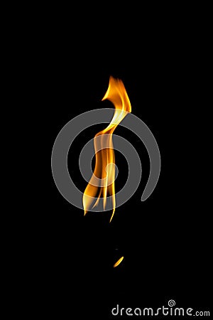 Closeup shot of an orange flame in the darkness Stock Photo