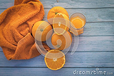 Closeup shot of orange fruits bunch on a wooden surface- fresh-squeezed orange juice concept Stock Photo