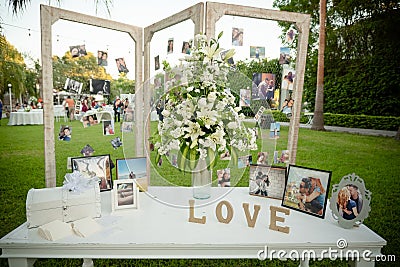 Closeup shot of an outdoor wedding decorations with photos Editorial Stock Photo