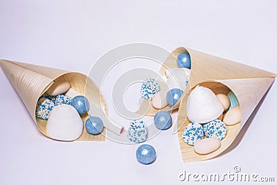 Closeup shot of paper cons filled with decorative shells and candy for a wedding table Stock Photo
