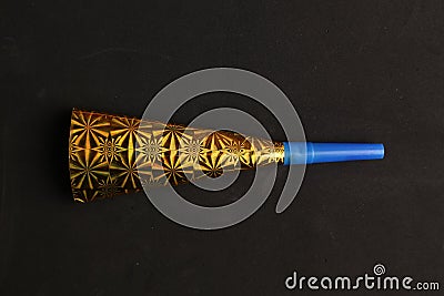 Closeup shot of a party noisemaker isolated on a black background Stock Photo