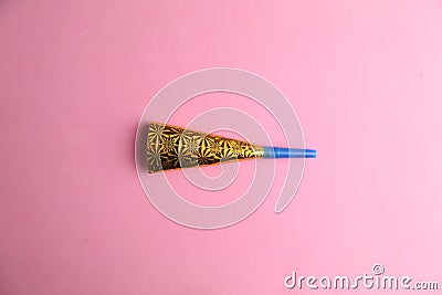 Closeup shot of a party noisemaker isolated on a pink background Stock Photo