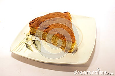 Closeup shot of a piece of homemade baked pie on white plate isolated on a white background Stock Photo