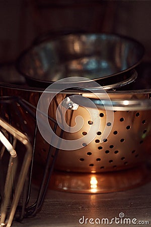 Closeup shot of a pile of metal pots on a shelf Stock Photo