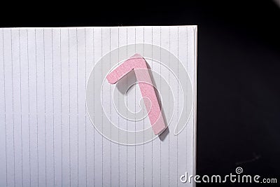 Closeup shot of a pink sign of number seven on a white paper on a black background Stock Photo