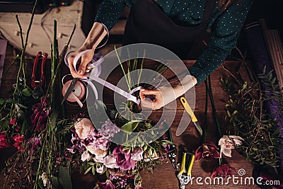 Closeup shot of process of tighting ribbon on flowers Stock Photo