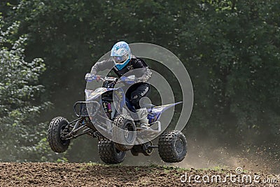 Closeup shot of quad rider in black jumping Editorial Stock Photo