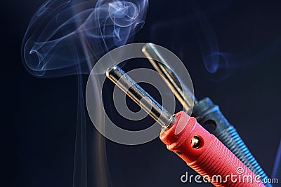 Closeup shot of red and black banana plug connectors on background of smoke Stock Photo