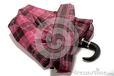 Closeup shot of a red checkered umbrella under the lights isolated on a white background Stock Photo
