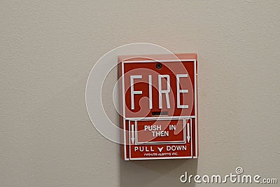 Closeup shot of the red fire alarm pull on the white wall Editorial Stock Photo