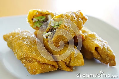 Closeup shot of roasted beef, onions, and lettuce in fried tacos Stock Photo